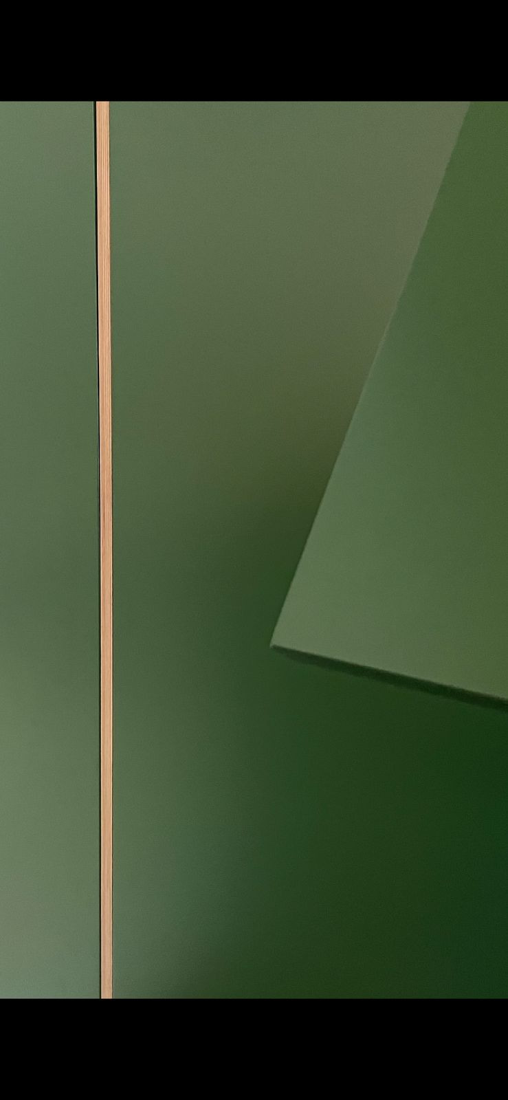 Detail view of one of the under-stair compartments, showing the painted finish and tailored interior.